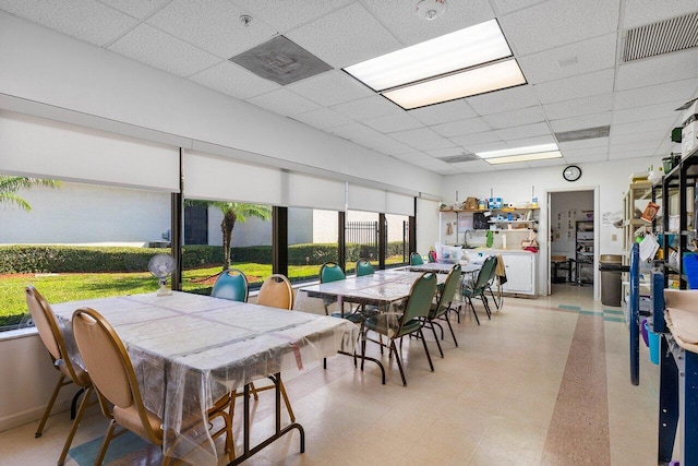 dining space featuring a drop ceiling