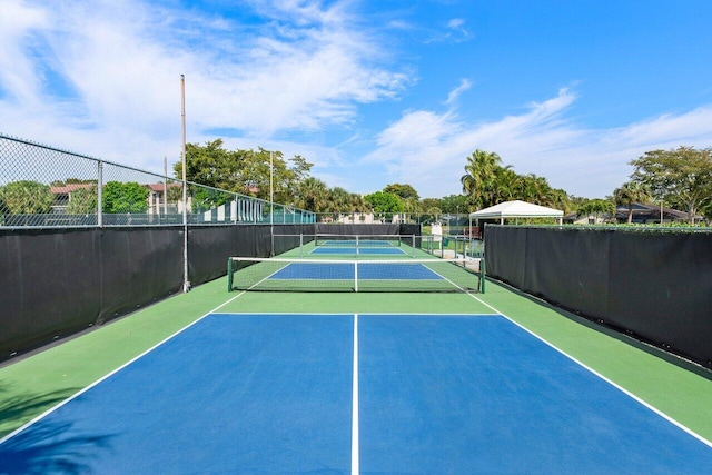 view of tennis court featuring basketball hoop