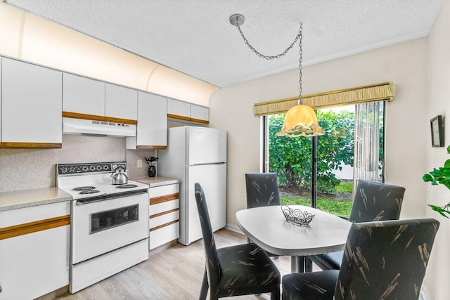 kitchen with light hardwood / wood-style floors, a textured ceiling, decorative light fixtures, white appliances, and white cabinets