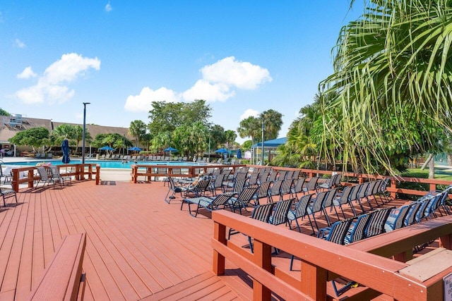 wooden deck featuring a community pool