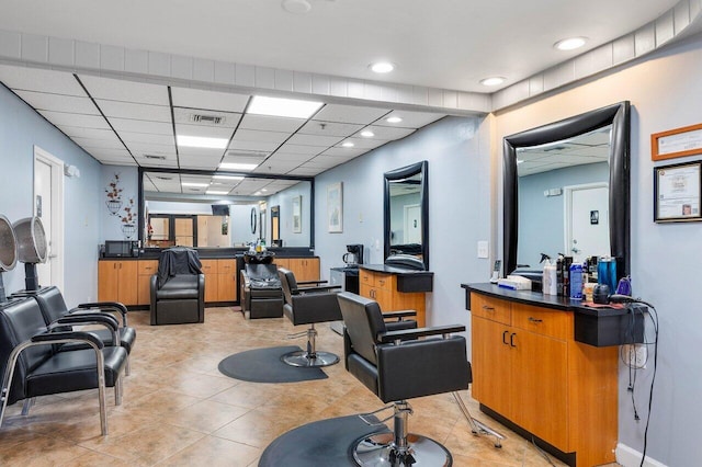 misc room featuring a drop ceiling and light tile patterned flooring