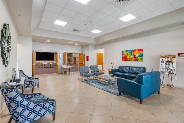 tiled living room with a drop ceiling