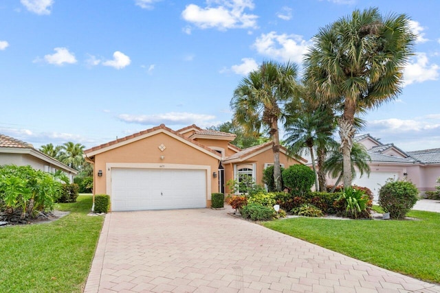 view of front of house with a garage and a front lawn