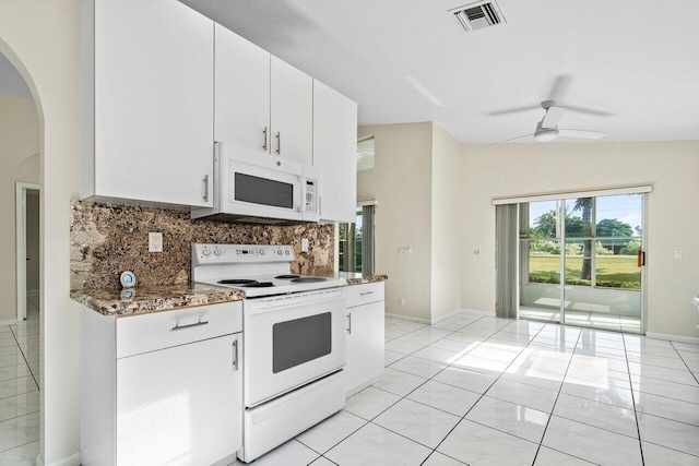 kitchen featuring white cabinets, tasteful backsplash, white appliances, and vaulted ceiling