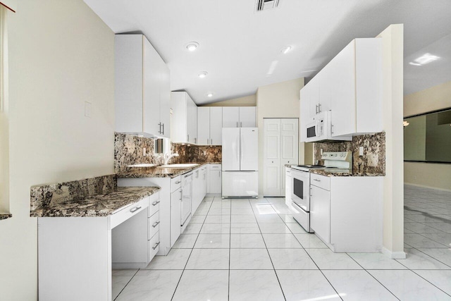 kitchen featuring lofted ceiling, white appliances, backsplash, dark stone counters, and white cabinets