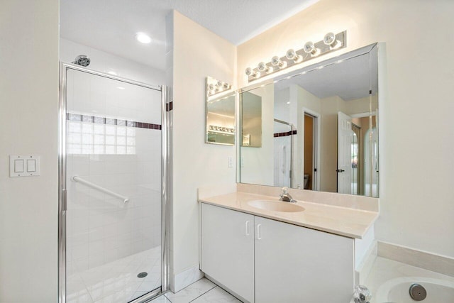 bathroom featuring vanity and shower with separate bathtub