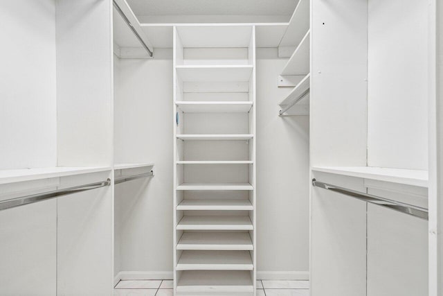 walk in closet featuring light tile patterned flooring