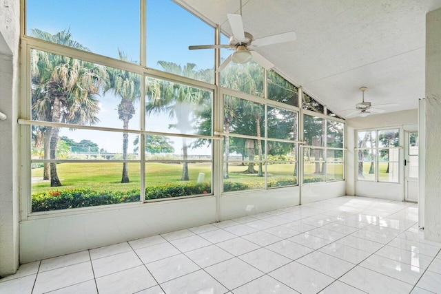 unfurnished sunroom with ceiling fan and vaulted ceiling