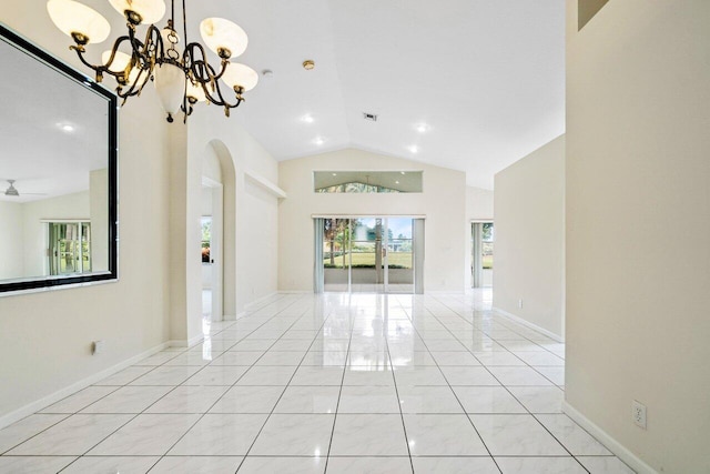 empty room with light tile patterned floors, ceiling fan with notable chandelier, and lofted ceiling