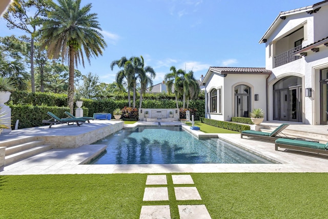 view of swimming pool featuring a patio and a lawn