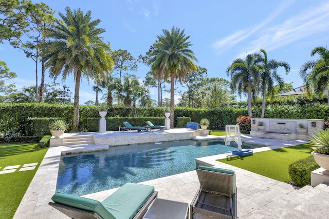 view of swimming pool featuring a lawn and a patio area