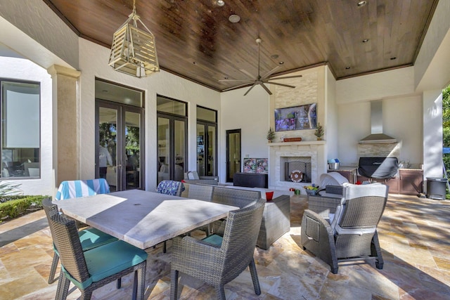 view of patio / terrace with ceiling fan and an outdoor fireplace