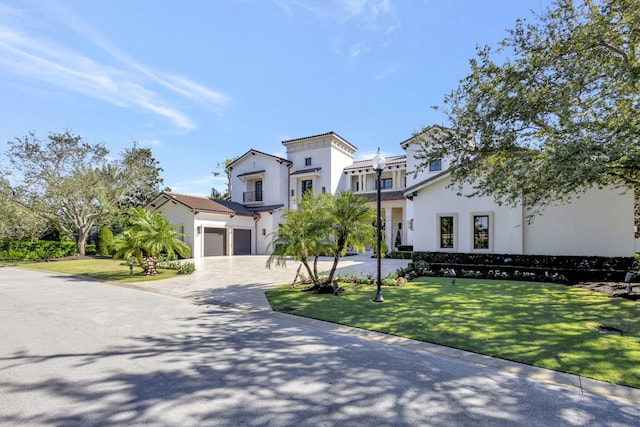 view of front of home with a front yard and a garage