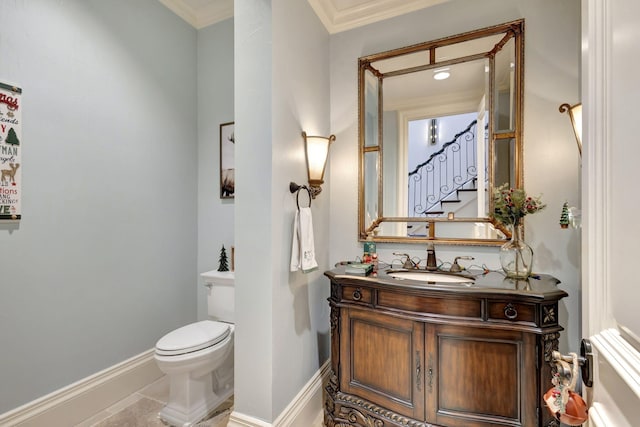 bathroom with tile patterned flooring, vanity, toilet, and crown molding