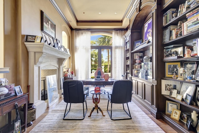 interior space with a tray ceiling, crown molding, and hardwood / wood-style flooring