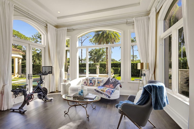 sunroom / solarium with a raised ceiling, a wealth of natural light, and french doors