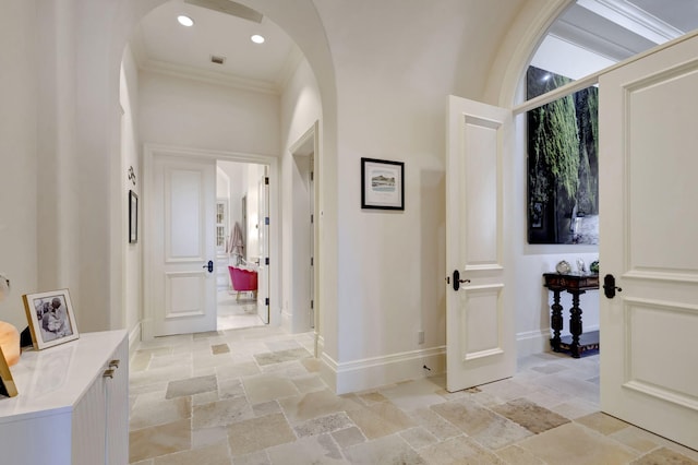 hallway featuring ornamental molding