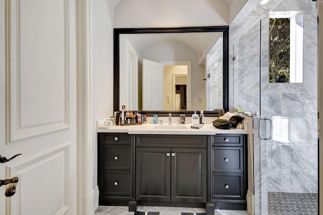 bathroom with vanity and a shower with shower door