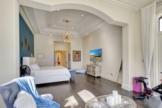 bedroom featuring a notable chandelier, dark hardwood / wood-style flooring, ornamental molding, and a tray ceiling