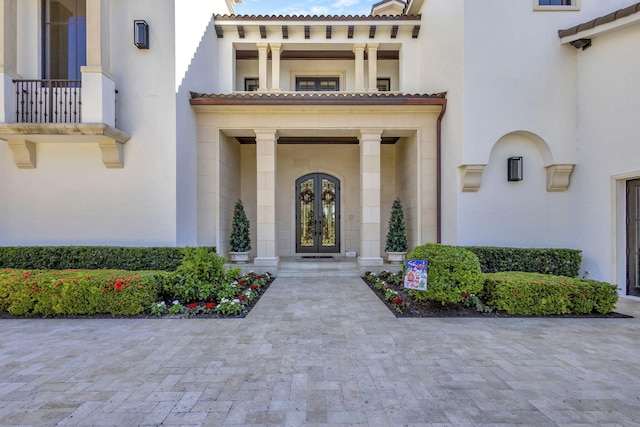 view of exterior entry featuring french doors