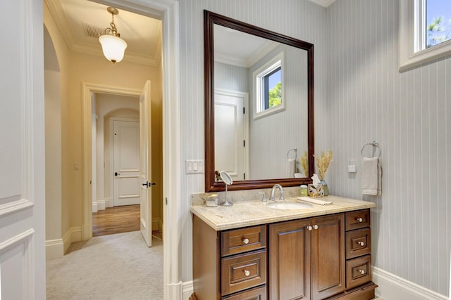 bathroom featuring crown molding and vanity