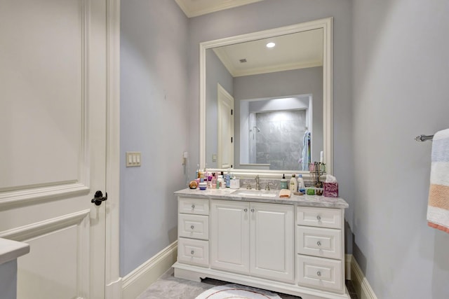 bathroom with a shower, vanity, and crown molding