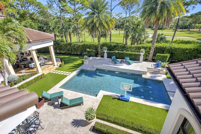 view of pool featuring a patio area and a yard