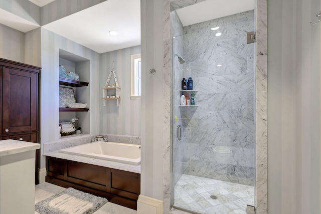 bathroom featuring separate shower and tub