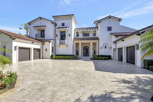 mediterranean / spanish-style house featuring a balcony and a garage