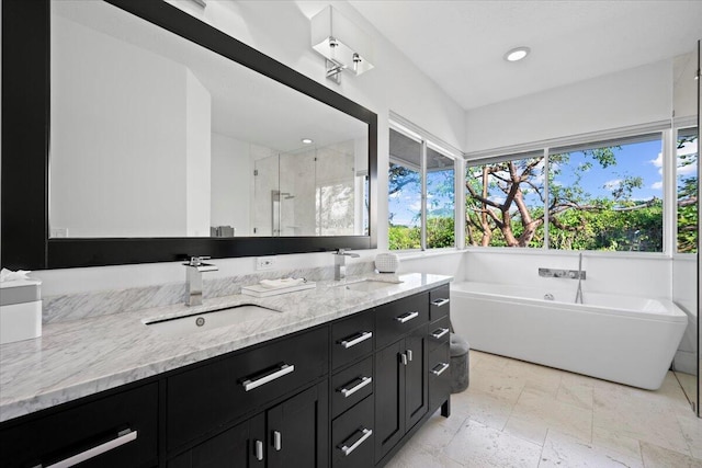 bathroom featuring shower with separate bathtub and vanity