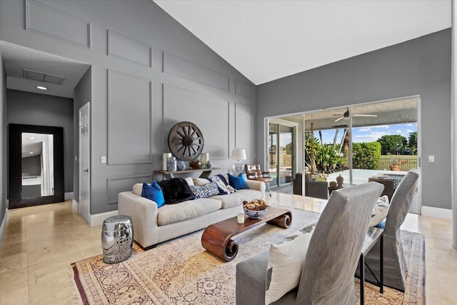 living room with ceiling fan and lofted ceiling