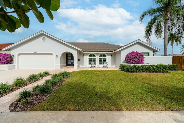 ranch-style home featuring a front lawn and a garage