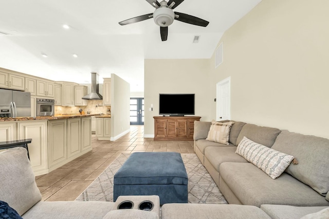 living room with ceiling fan and vaulted ceiling