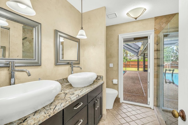 bathroom with tile patterned flooring, vanity, and toilet