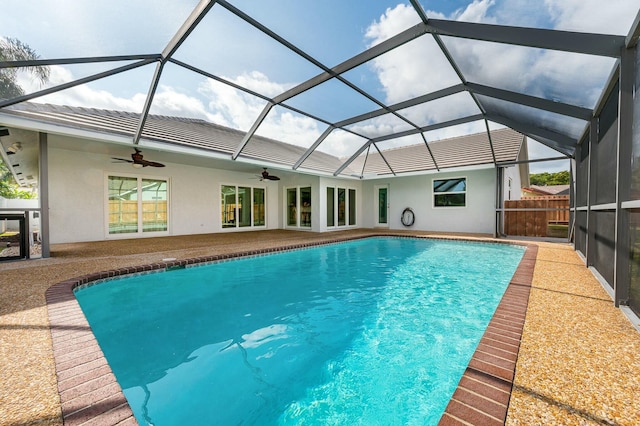 view of swimming pool with a lanai, ceiling fan, and a patio