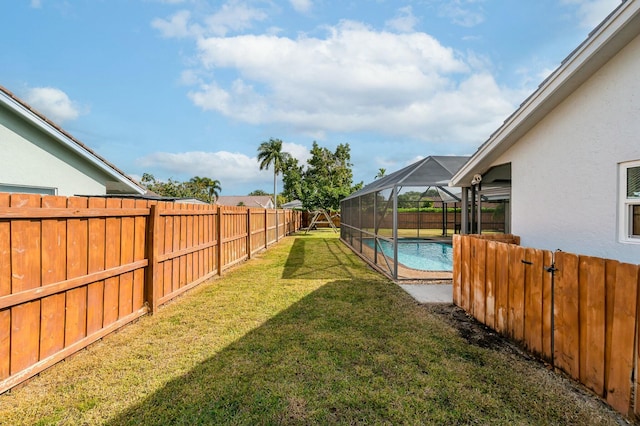 view of yard featuring a lanai and a fenced in pool