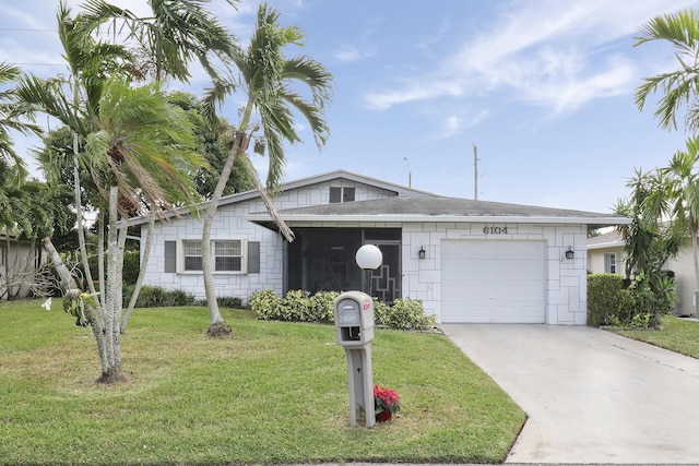 ranch-style house featuring a garage and a front lawn