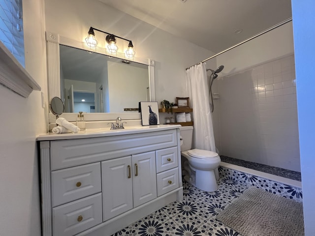 bathroom with tile patterned flooring, vanity, a shower with shower curtain, and toilet