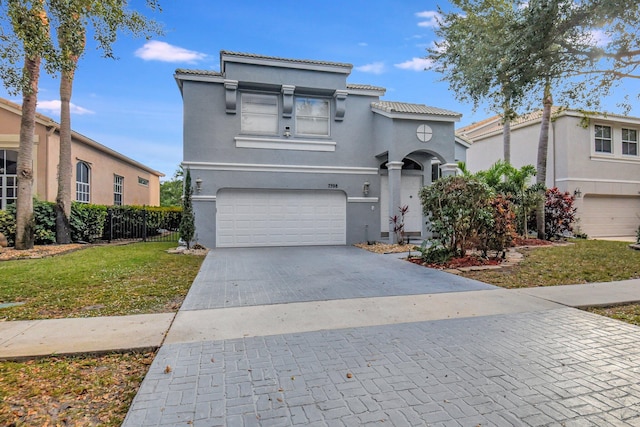 view of front of home featuring a garage and a front lawn