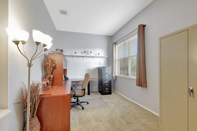 carpeted office with lofted ceiling