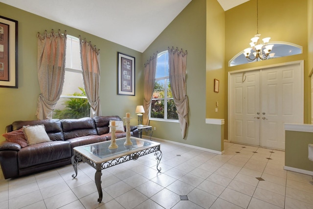 foyer entrance with light tile patterned floors, high vaulted ceiling, and a chandelier