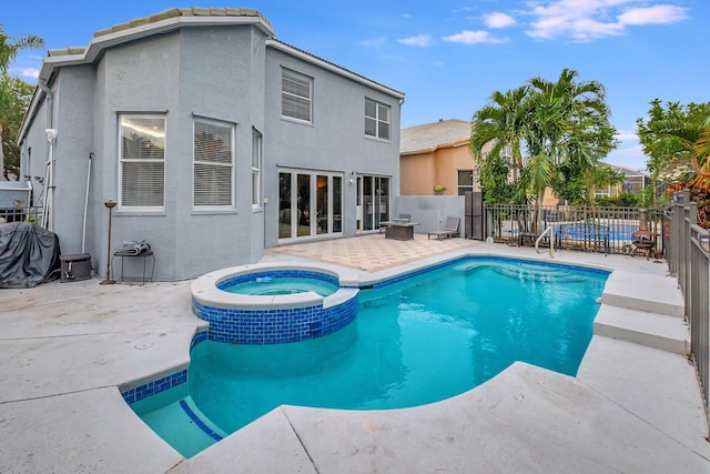 view of swimming pool with an in ground hot tub and a patio