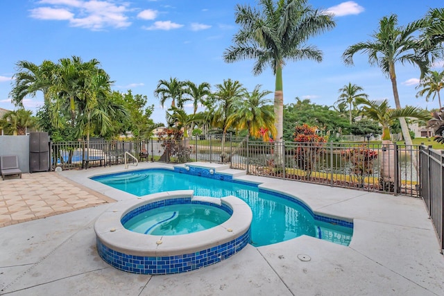 view of swimming pool with a patio area and an in ground hot tub