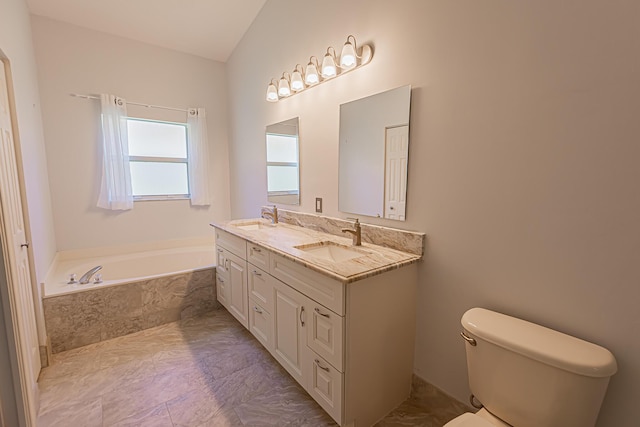 bathroom with a relaxing tiled tub, vanity, and toilet