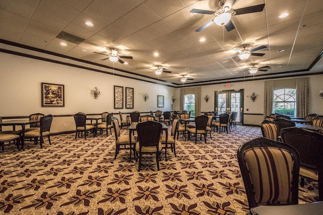 dining space with carpet floors, ornamental molding, and plenty of natural light