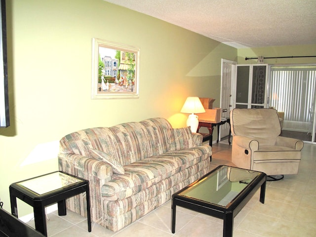 living room featuring light tile patterned floors and a textured ceiling