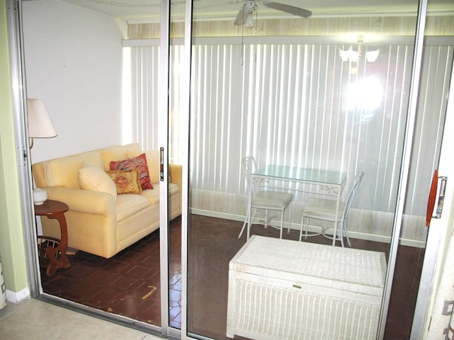 sunroom with ceiling fan with notable chandelier