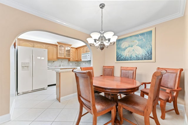 dining area featuring light tile patterned floors, a chandelier, and ornamental molding