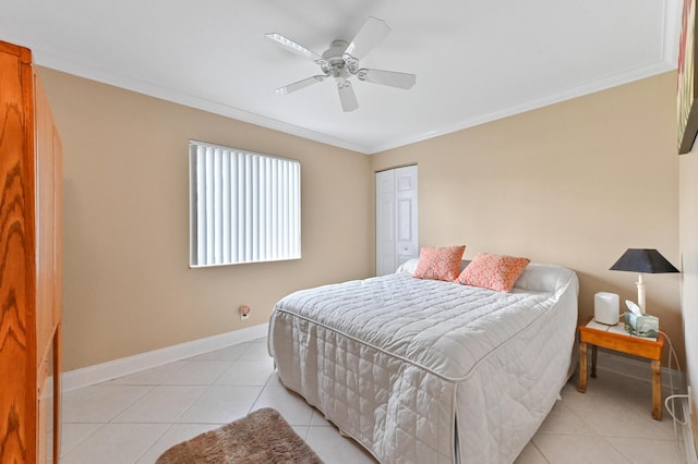 tiled bedroom with ceiling fan, crown molding, and a closet