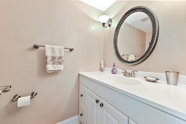 bathroom featuring visible vents, vanity, and baseboards